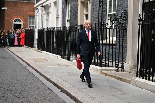 John Healey walking along Downing Street with his ministerial red box