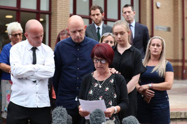 Tracy Lewis, centre, and Tony Benton, left, read a statement outside Woking Coroner’s Court