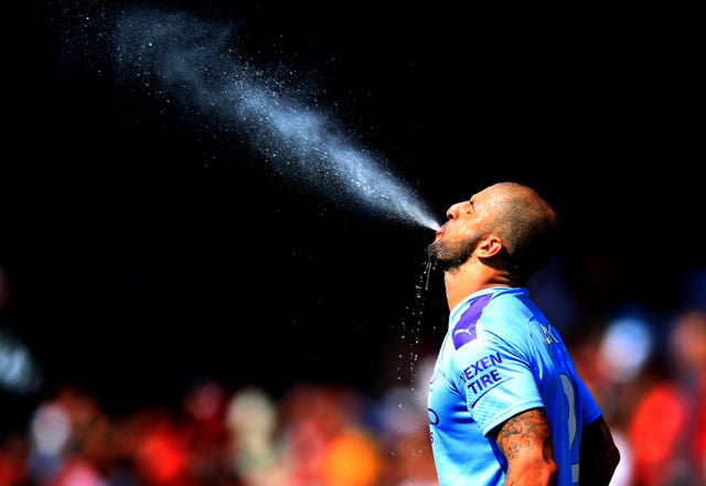 Manchester City's Kyle Walker spits out water ahead of the match 