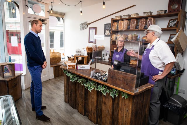 William chatting to bakery owners Paul and Teresa Brandon. Aaron Chown/PA Wire