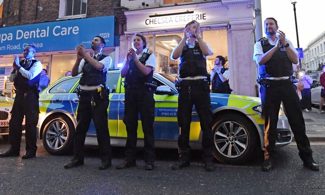 Clapping police officers outside the Chelsea and Westminster Hospital