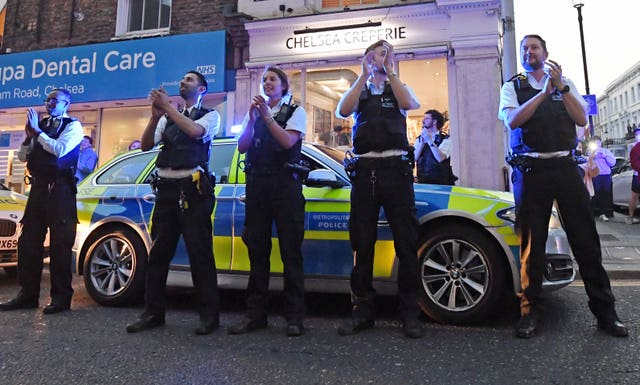 Clapping police officers outside the Chelsea and Westminster Hospital 