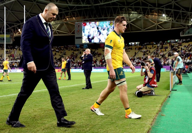 Cheika and Michael Hooper walk off the pitch dejected after defeat to England