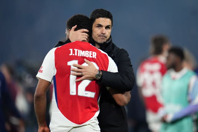 Arsenal manager Mikel Arteta (right) consoles Jurrien Timber following their Champions League defeat to PSG