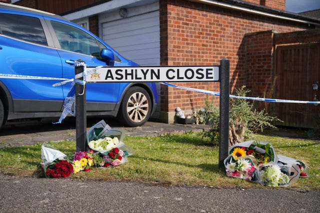 Flowers under the road sign for Ashlyn Close