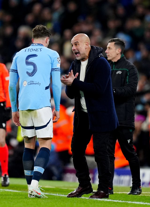 Manchester City manager Pep Guardiola, right, shouts instructions at John Stones during last season's Champions League match against Club Brugge