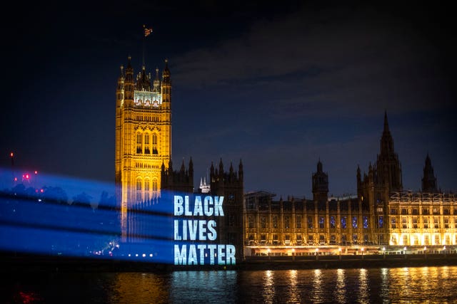 Black Lives Matter is projected onto the Houses of Parliament