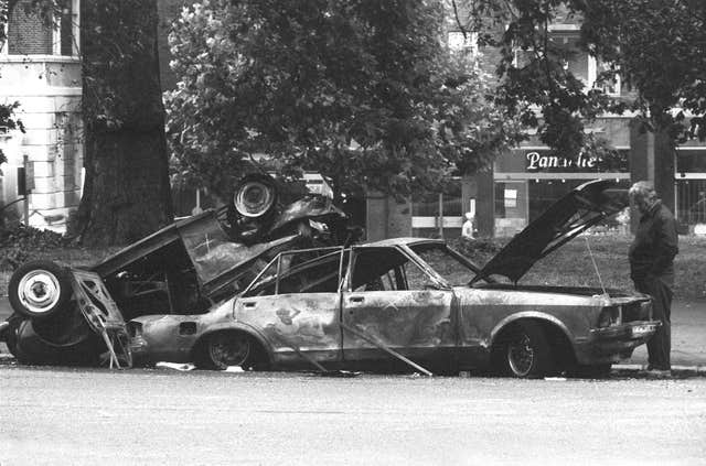 Police forensic officers working on the remains of the car which housed the Hyde Park car bomb in 1982