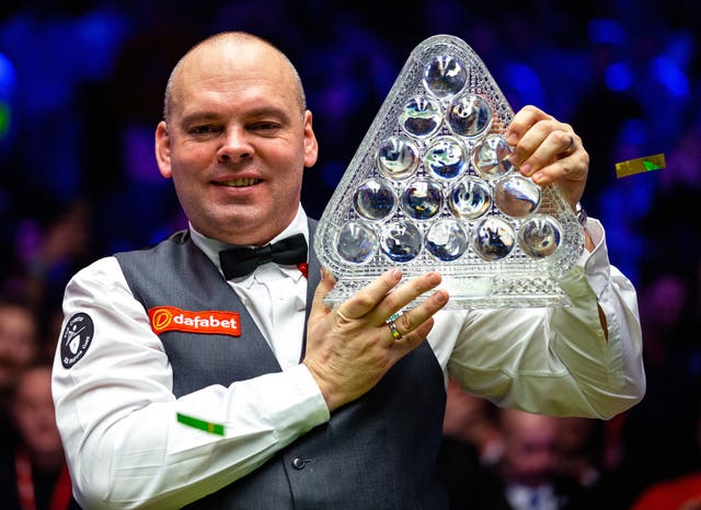 Stuart Bingham celebrates winning the Masters with the Paul Hunter trophy