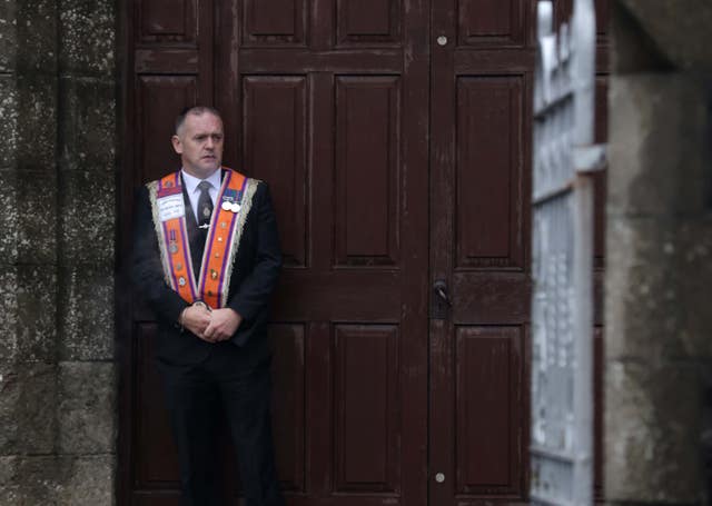 A member of the Orange Order outside Drumcree Parochial Hall in Portadown (Peter Morrison/PA)
