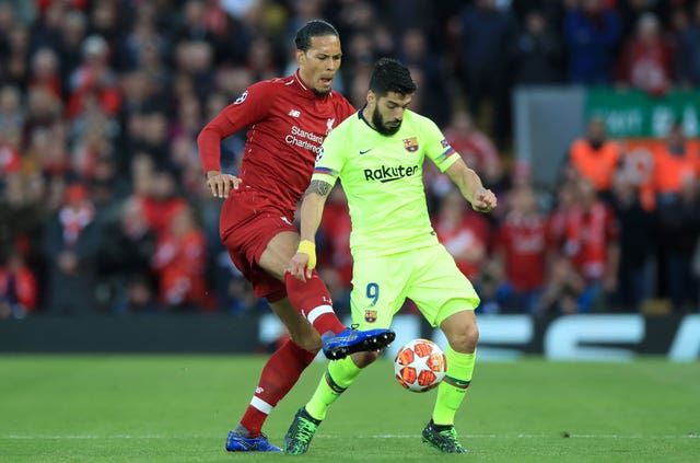 Liverpool's Virgil van Dijk (left) and Barcelona's Luis Suarez battle for the ball during the UEFA Champions League Semi Final, second leg match at Anfield, Liverpool