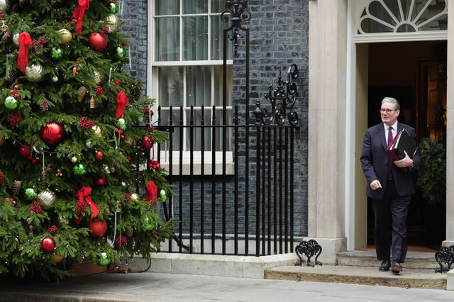 Sir Keir Starmer walking out of 10 Downing Street carrying folders