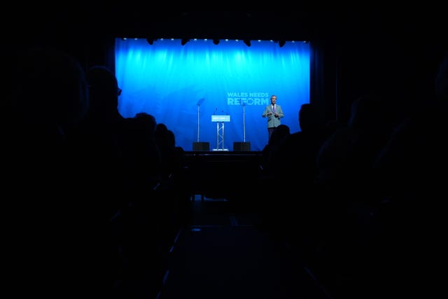 Reform leader Nigel Farage speaks during a Reform UK rally at Venue Cymru, Llandudno
