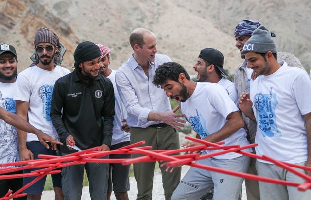 The Duke of Cambridge celebrates helping successfully complete a bridge-building exercise