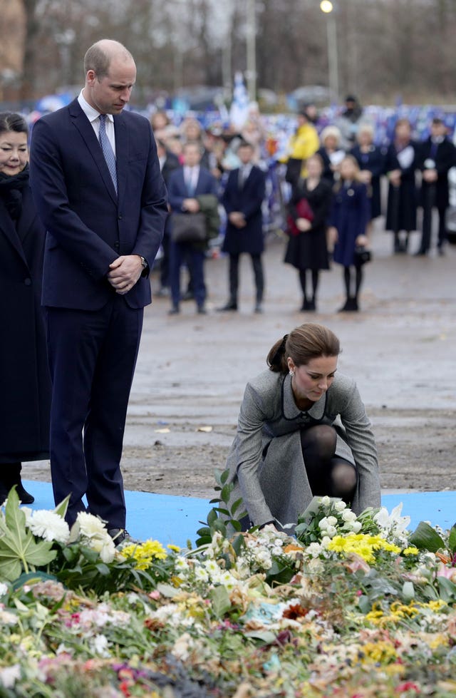 Kate lays flowers at the tribute site