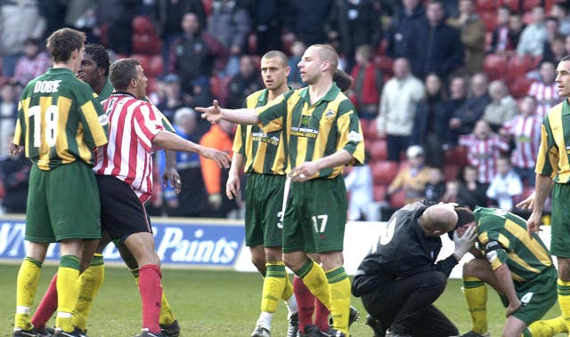 Keith Curle, centre left, loses his cool in the heat of the moment 