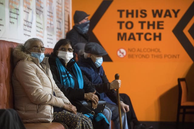 Patients prepare to receive the first of two injections with a dose of the Pfizer/BioNtech Covid-19 vaccine at The Hive in Harrow