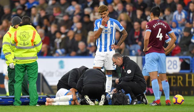 Chris Lowe receives treatment before being carried off