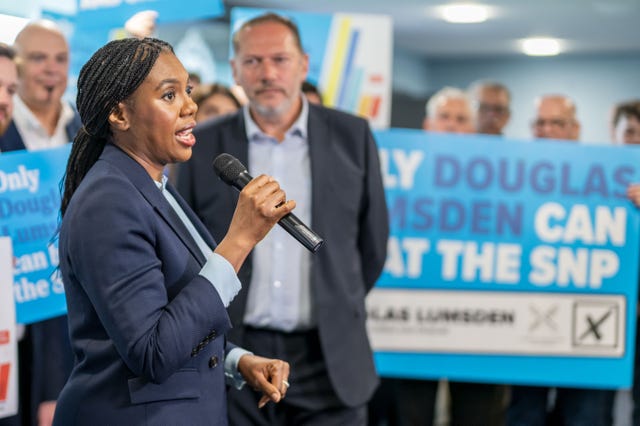 Kemi Badenoch speaking into a mic as Douglas Lumsden looks on