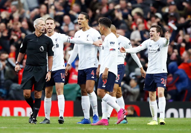 Liverpool players complain to referee Martin Atkinson about United's opener