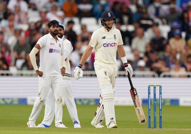 England's Joe Root smiles after India refer an LBW decision