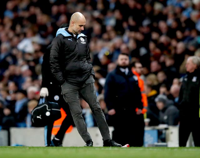 Manchester City manager Pep Guardiola kicks a bottle in frustration after Fernandinho scores an own goal 