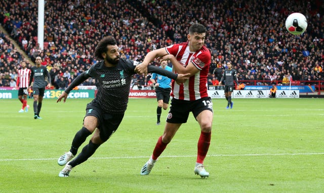 Sheffield United centre-back John Egan, pictured battling for the ball against Liverpool's Mo Salah, is a doubt for the match against Manchester United due to a clash of heads while on Republic of Ireland duty