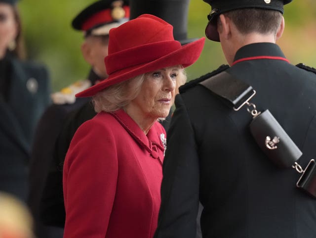 Camilla in a striking red wool outfit