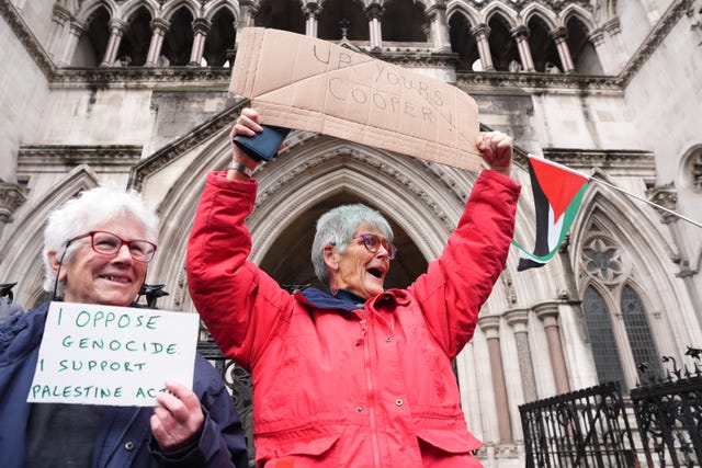 Protesters holding placards outside the High Court