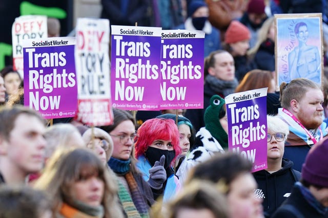 A rally involving trans rights campaigners, many carrying placards reading 'Trans rights now'