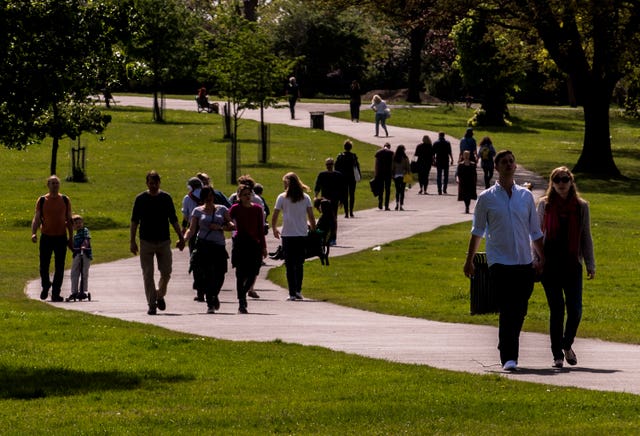 People walking along a path in the warm weather