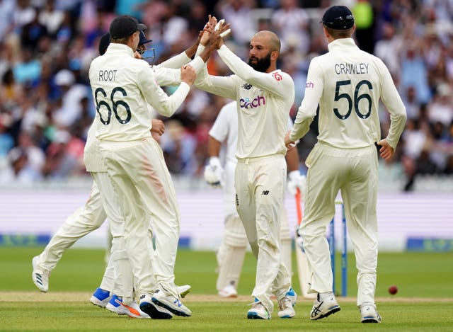 Moeen Ali (centre) celebrates a wicket