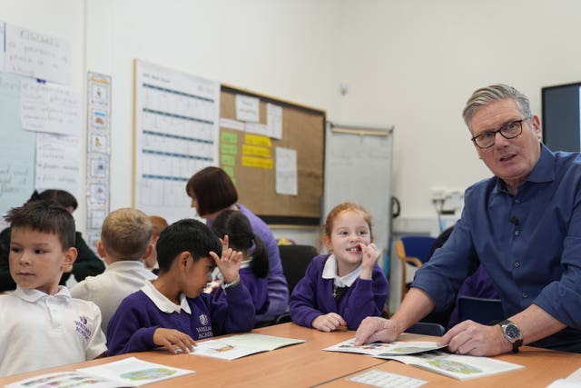 Prime Minister Sir Keir Starmer reading with pupils