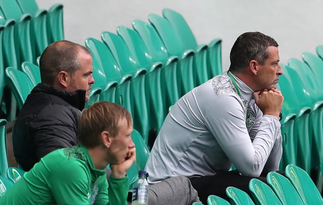 Jack Ross, right, sitting in the deserted stands during a pre-season friendly at Celtic