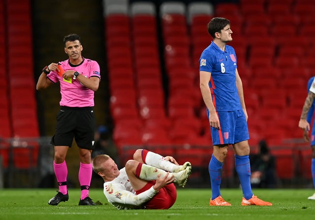 Harry Maguire, right, reacts after being sent off