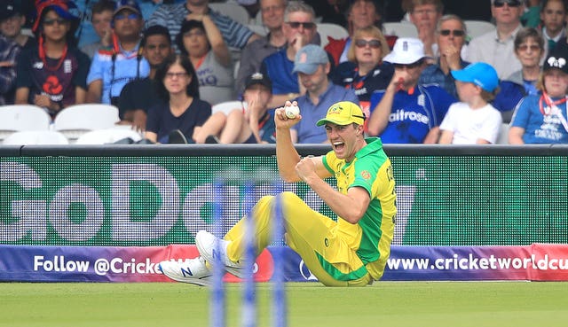 Australia's Pat Cummins celebrates taking the catch to dismiss Eoin Morgan