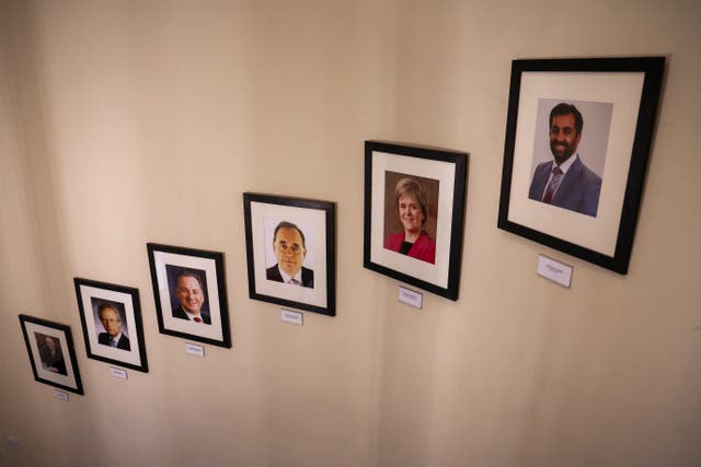 Framed photo of first ministers from Donald Dewar to Humza Yousaf, placed on a wall of a staircase