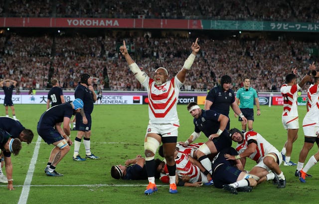 Japan's players start their celebrations after victory over Scotland sends the hosts through to the World Cup quarter-finals 