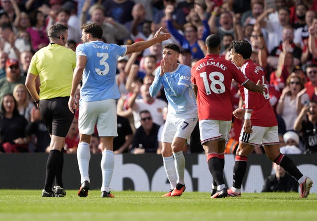 Phil Foden reacts after being shown a red card by referee Michael Oliver