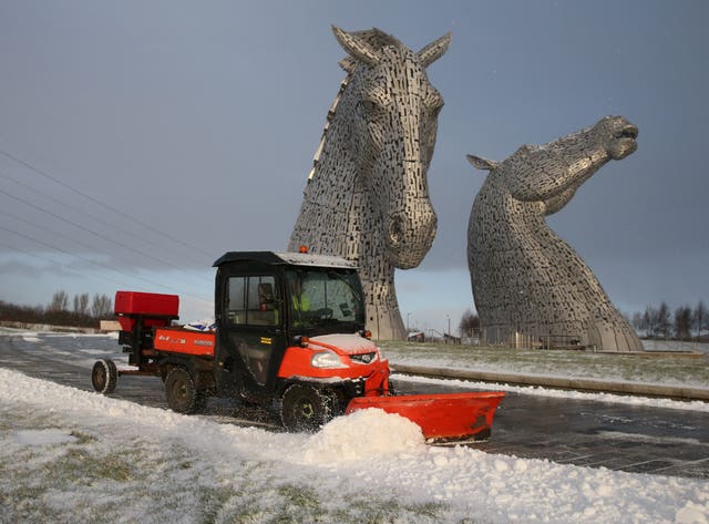 Snow is cleared from a pathway at the Kelpies near Falkirk
