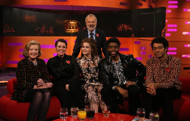 Host Graham Norton with (seated left to right) Lady Anne Glenconner, Olivia Colman, Helena Bonham Carter, Chadwick Boseman and Richard Ayoade