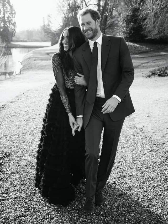 Meghan in a Ralph & Russo gown, with Harry (Alexi Lubomirski/PA)