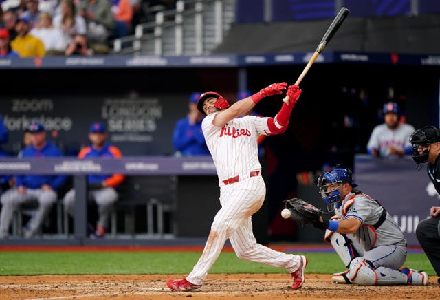 Whit Merrifield swings his bat during the MLB London Series