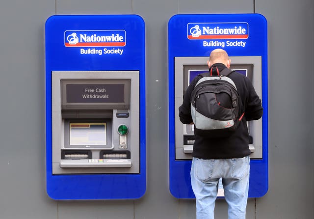 A person using an ATM