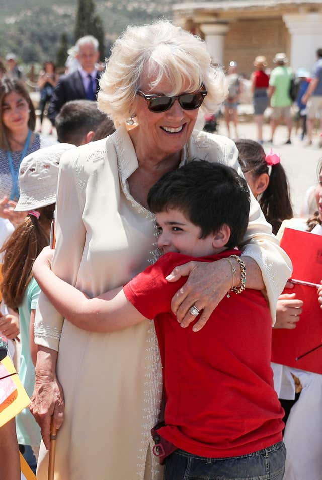 The duchess won a hug from Constantine Faitakis while meeting schoolchildren (Andrew Matthews/PA)