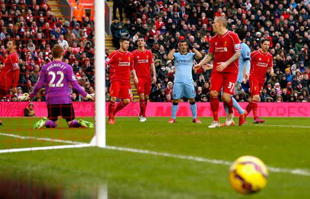 Aguero, centre, sees his shot roll just wide