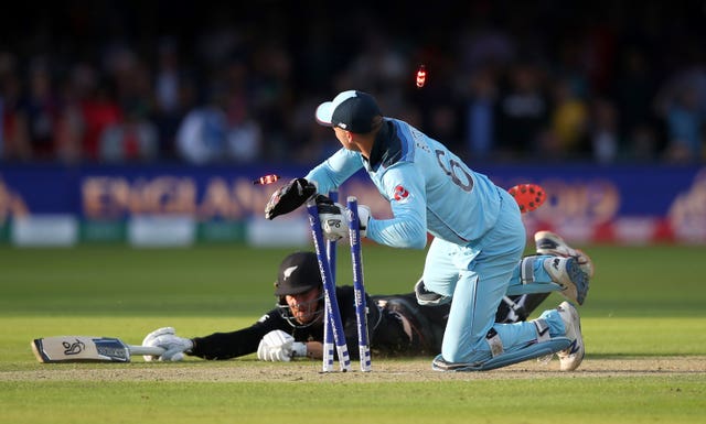 England's Jos Butler runs out New Zealand's Martin Guptill to win the match for England