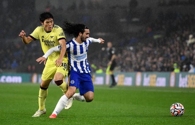 Arsenal’s Takehiro Tomiyasu, left, and Brighton''s Marc Cucurella battle for the ball