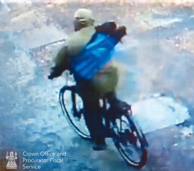 CCTV image of a man on a bike, with a bag slung over his back