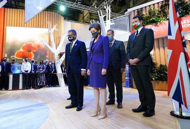 Cop26 president Alok Sharma, front left, and First Minister Nicola Sturgeon observe a two-minute silence to remember the war dead on Armistice Day in the UK Pavilion at the Scottish Event Campus (SEC) in Glasgow during the Cop26 climate summit